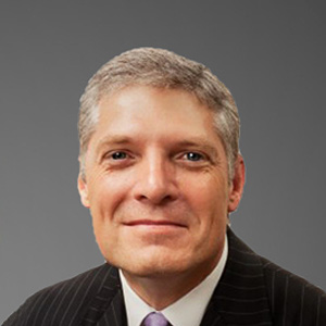 a man in a suit smiling
