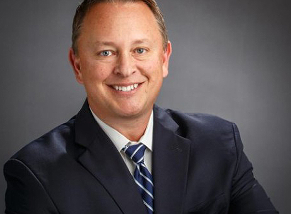 a man in a suit smiling