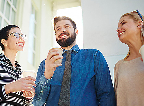 a man standing with coworkers