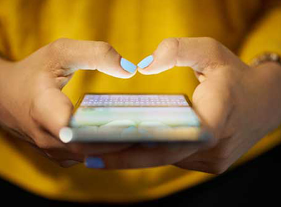 a woman typing on her phone