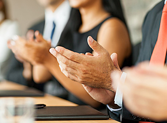people clapping during a business meeting