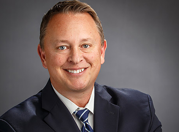 a man wearing a suit and smiling