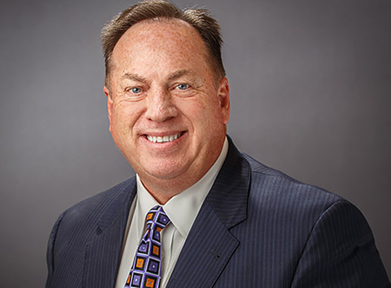 a man in a suit smiling