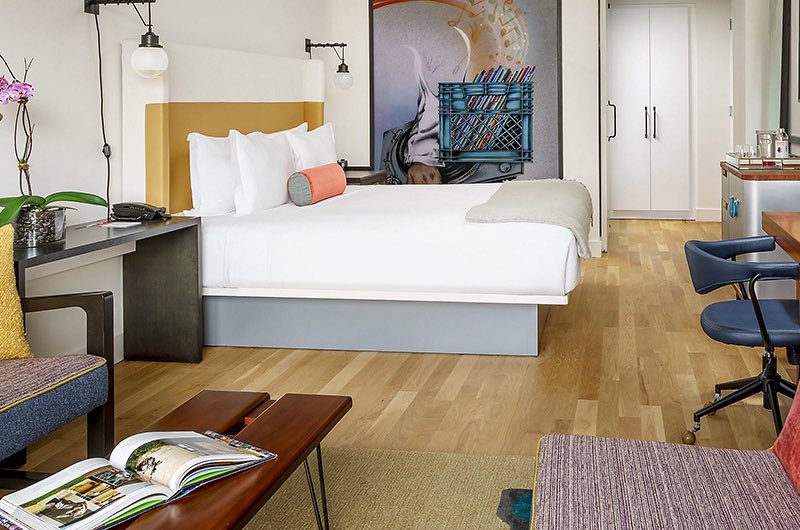 a guest room with white linens on the bed