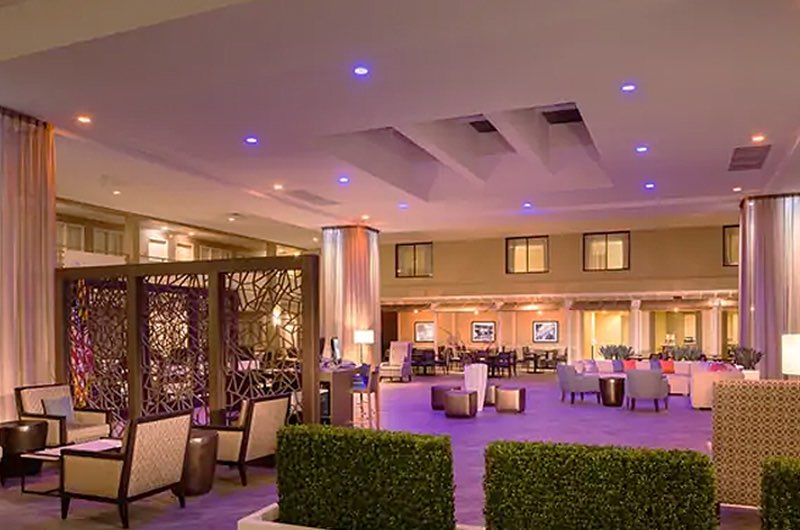 the lobby area inside of a property with purple uplighting