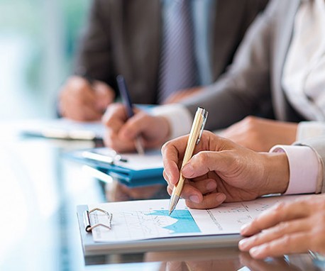 people writing notes during a business meeting