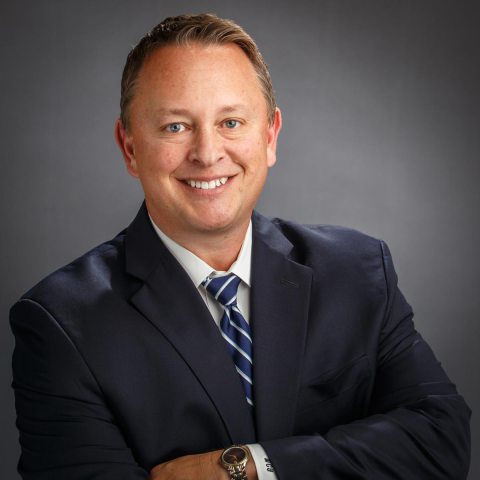 a man in a suit smiling