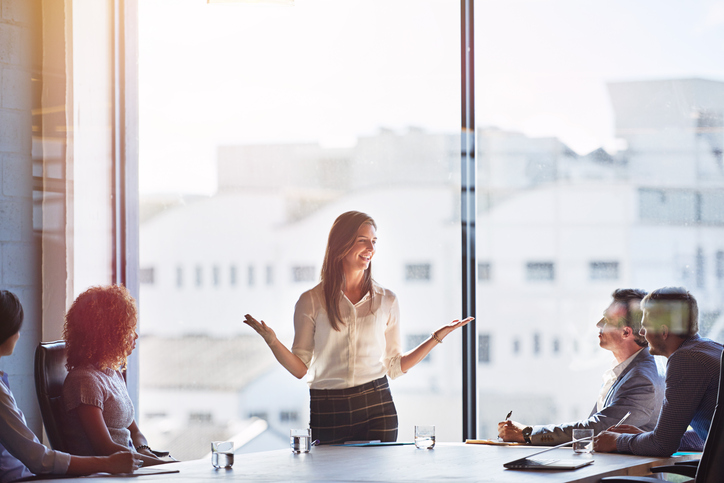 a woman talking during a business meeting