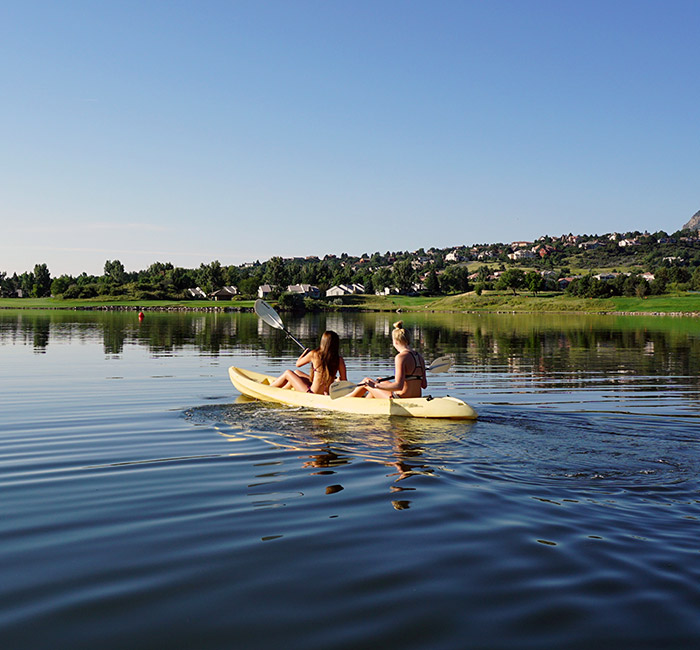 people kayaking down a river