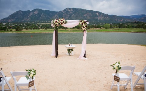A wedding set up next to a lake 