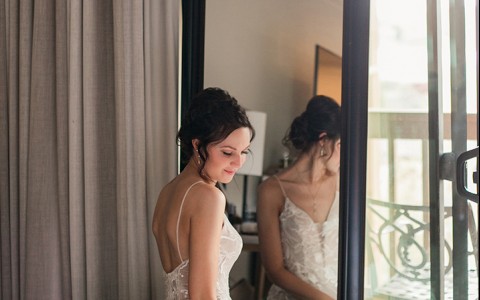 A beautiful bride sitting in front of a mirror