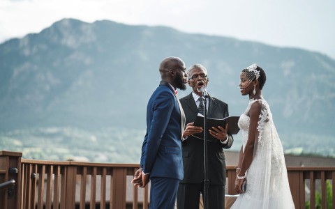A lovely black couple getting married outdoors