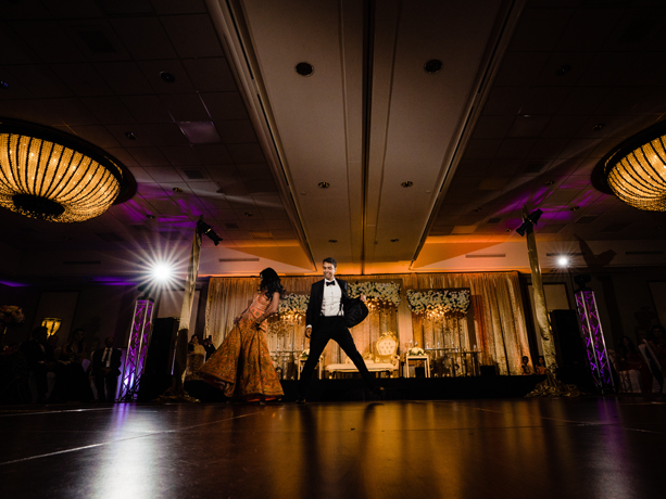 View of a couple dancing on a big ballroom 