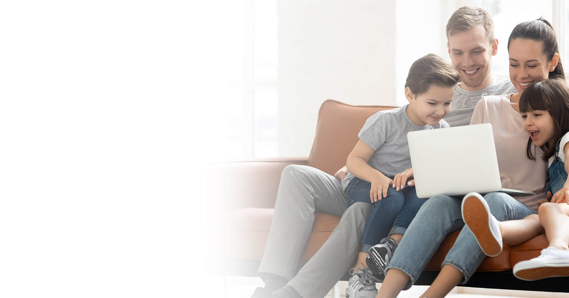 family looking at laptop