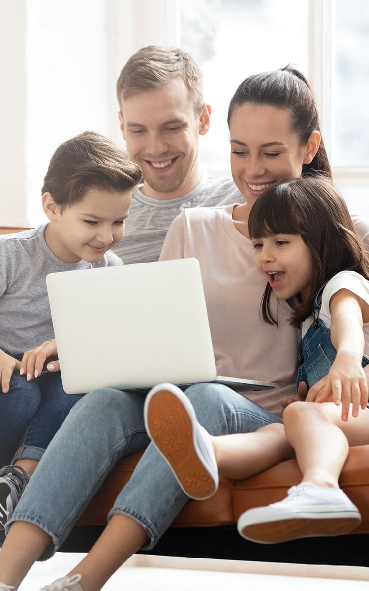 family looking at laptop