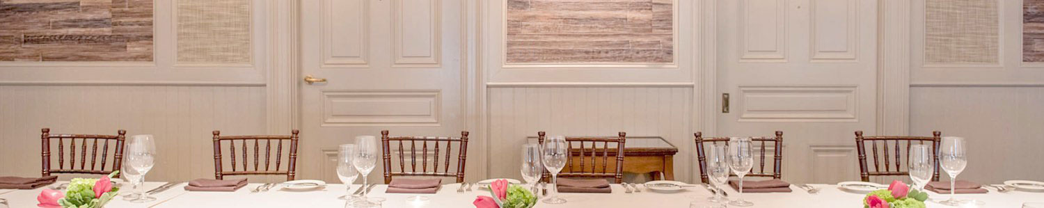 Room with long rectangular table set for meal