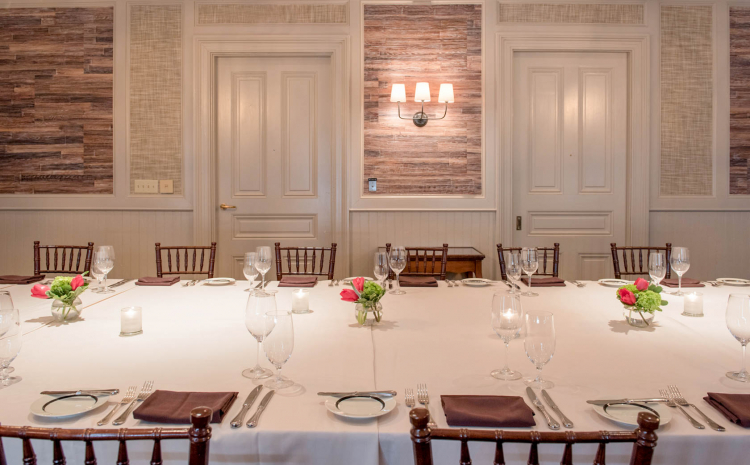Room with long rectangular table set for meal