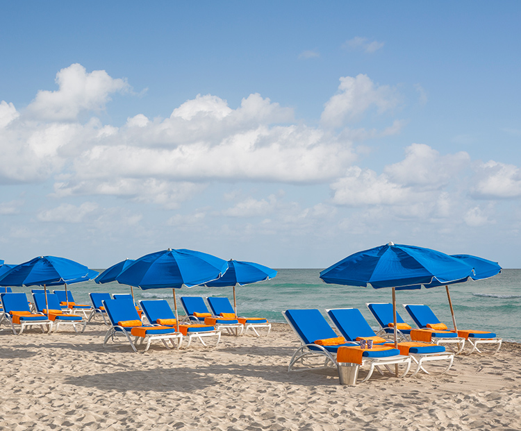 circa 39 row of lounge chairs along the beach