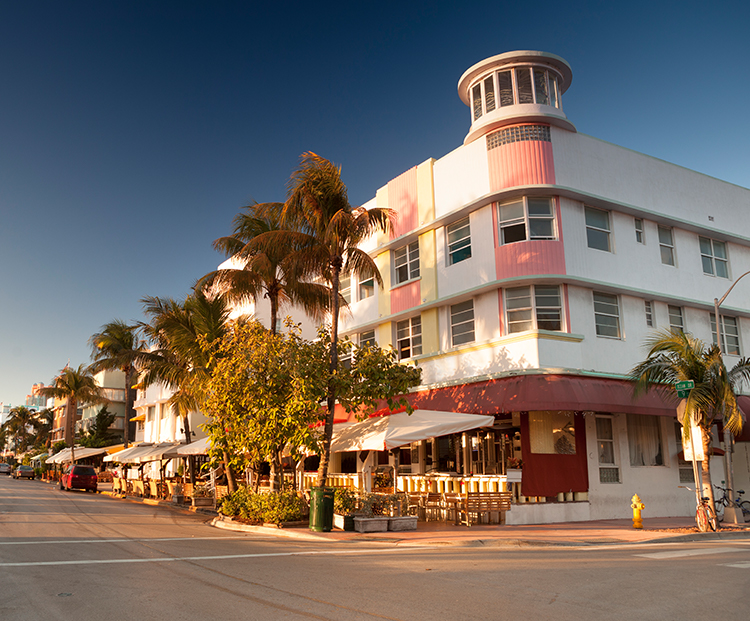 Miami Beach white and pink art deco building on the corner of a street