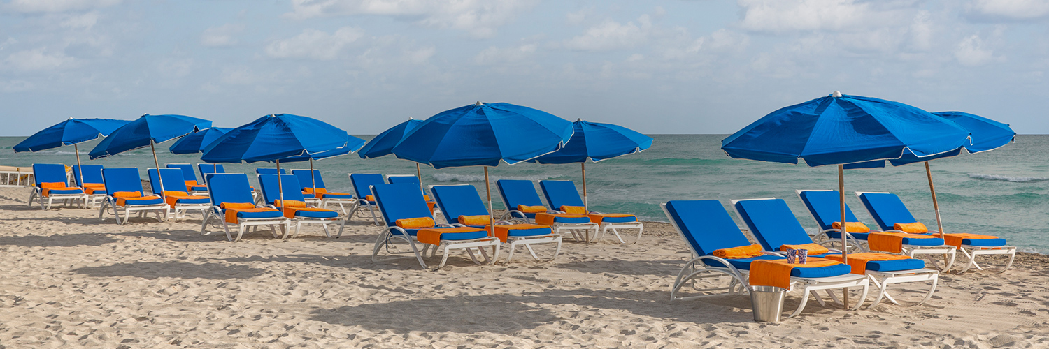 circa 39 row of lounge chairs along the beach