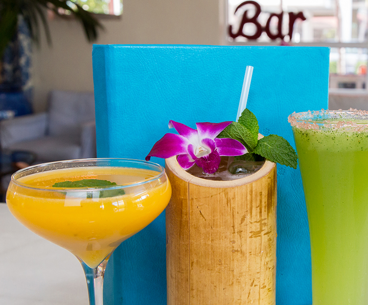 range of four cocktails in decorative tropical glasses