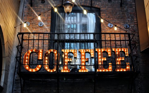 letter sign lighting up with the word coffee in a building 