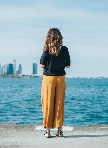 woman standing and looking at the river in the lincoln park