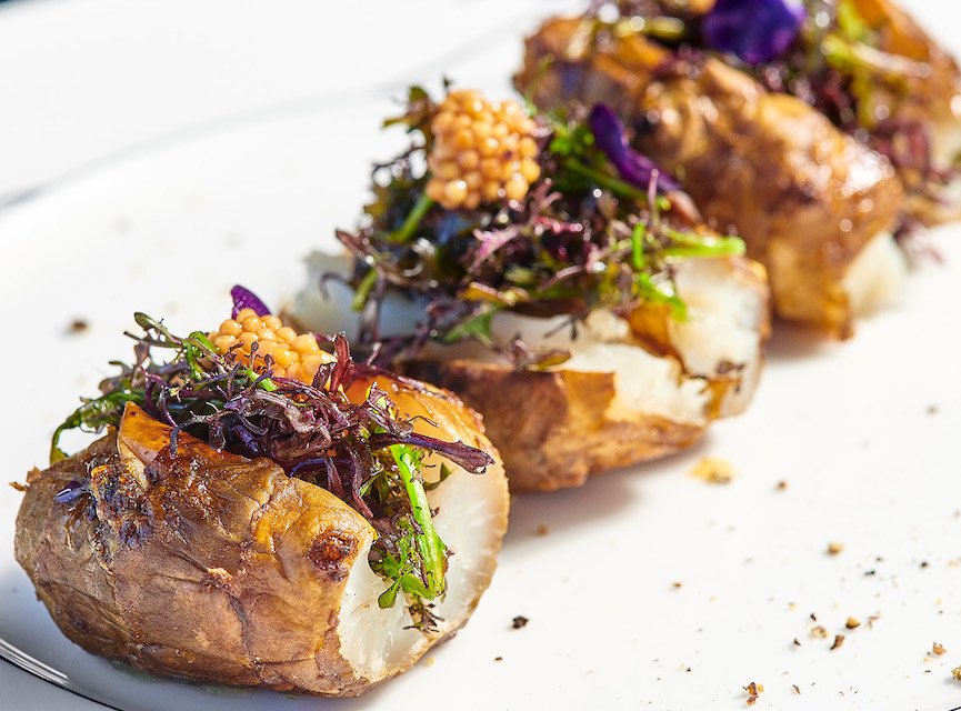 close up of a dish of potatoes with garnishing