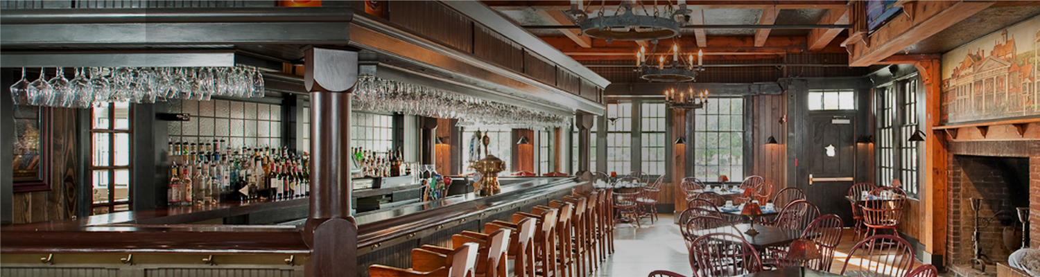 a long wood bar with wood chairs
