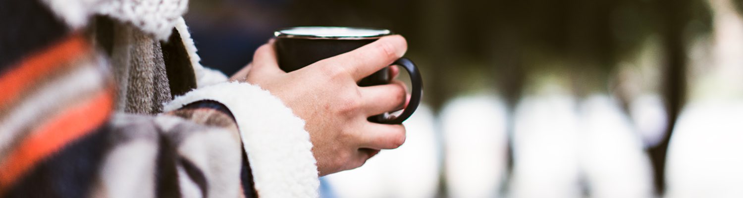 a woman drinking a cup of coffee