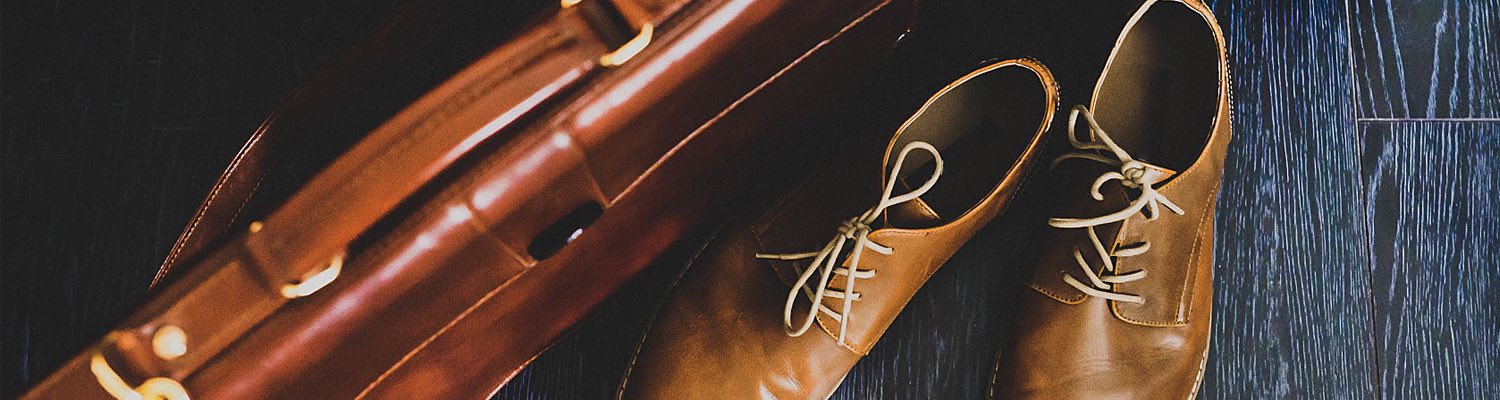 a briefcase with leather shoes