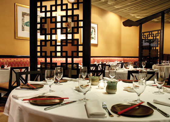 Chopstix restaurant with wine glasses, plates & chopsticks on table
