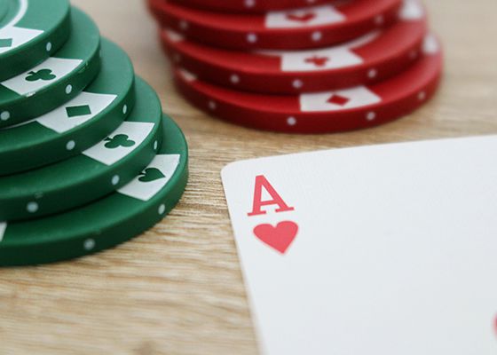 Ace of hearts card next to poker chips