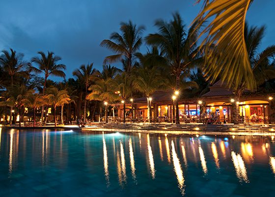 Kiosk next to pool lit up at night