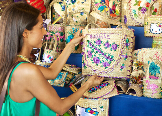Woman shopping at Nassau Market through artisanal bags