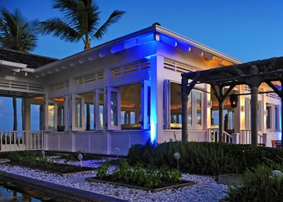 Dune restaurant white building entrance with rock and greenery landscape