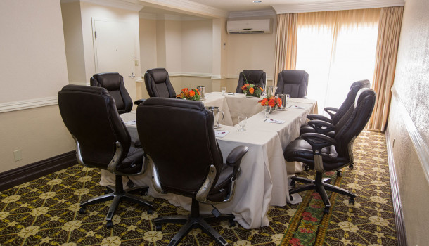 Meeting room black chairs around rectangle table set up