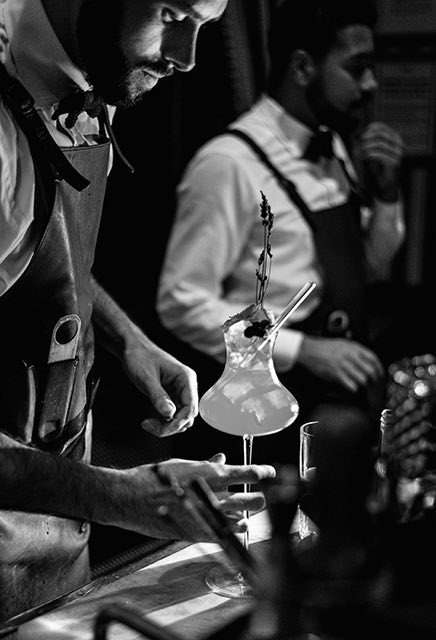 bartenders making unique cocktails black and white