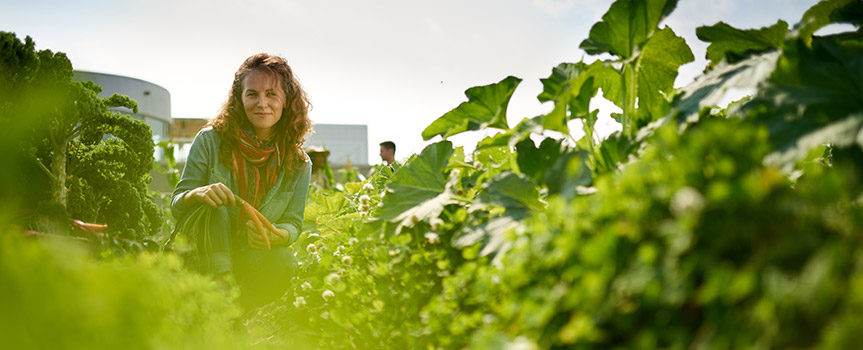 woman walking in garden with greens