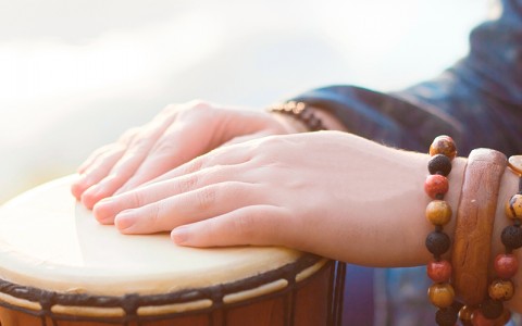 close up of hands resting on a drum