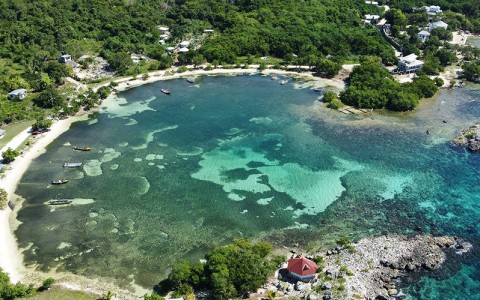 aerial view of resort property showcasing coastline of cove