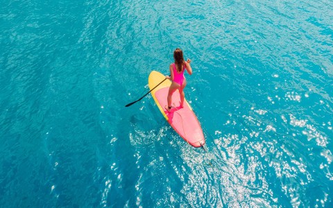 aerial view of woman paddle boarding