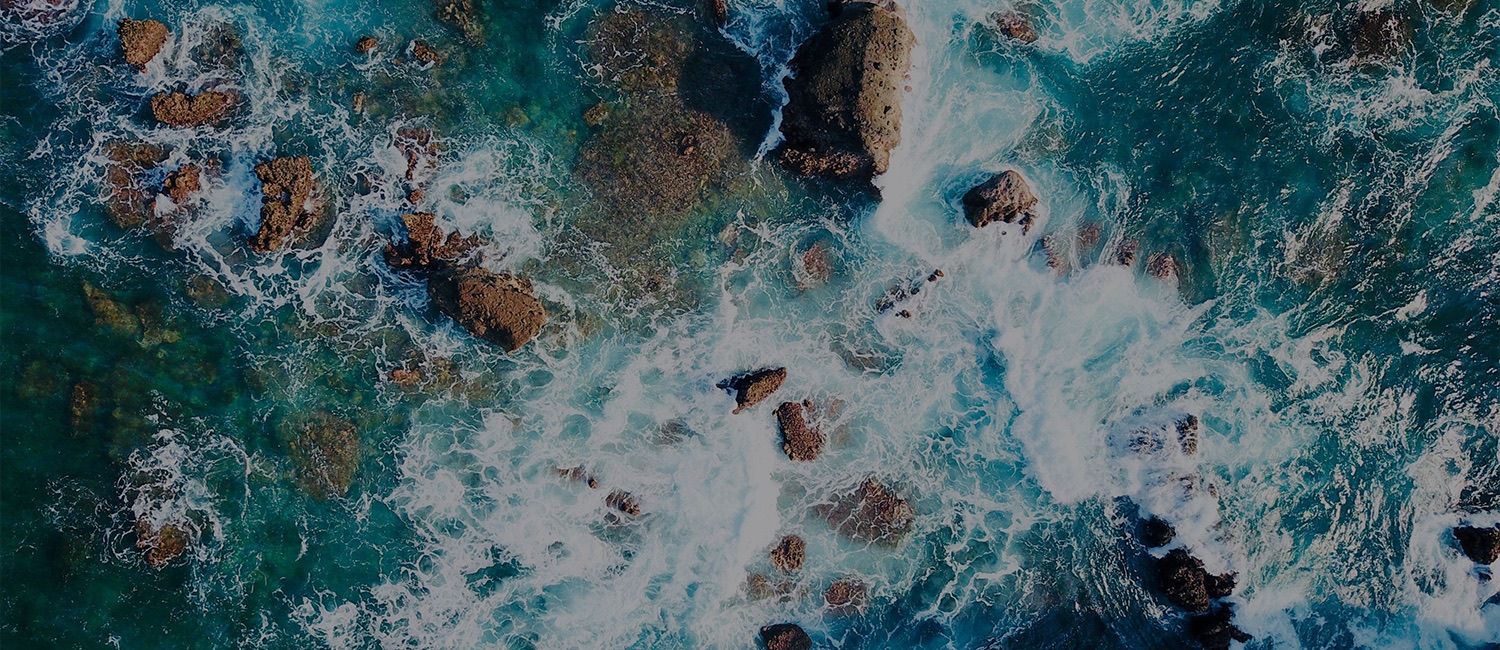 aerial view of the ocean and some rocks 