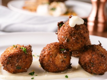 Another close up of crab croquettes and aioli sauce