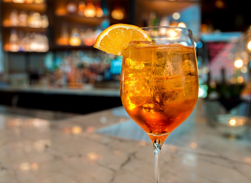 image of aperol spritz on bar with organge