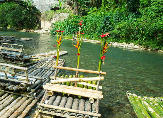 several handmade rafts made of bamboo in the water