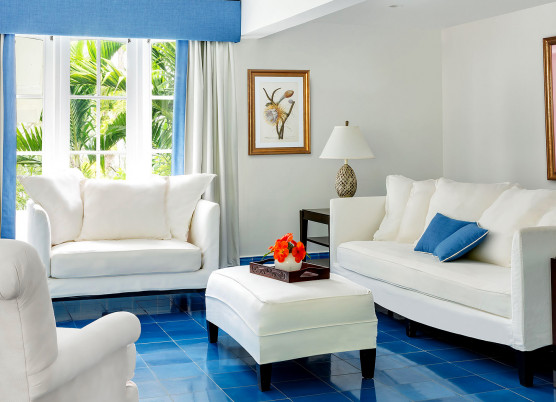 hibiscus cottage living room with white furniture and blue flooring
