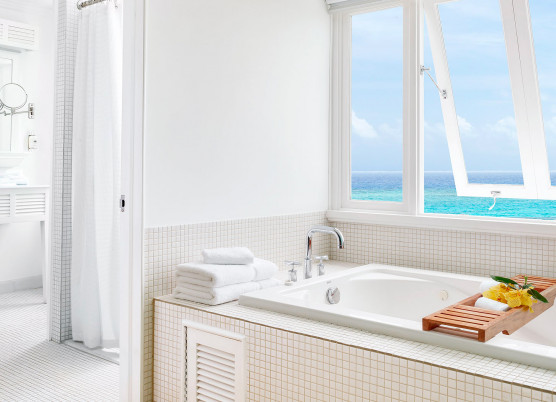bathroom with white decorations and a window open overlooking the ocean