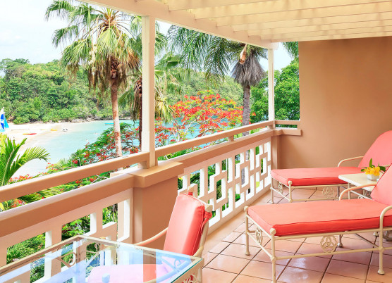 prime ministers penthouse suite balcony area with coral furniture overlooking beach