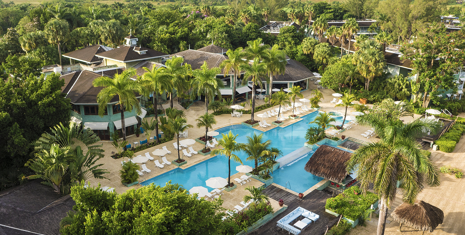 aerial image of the resort surrounded by tropical trees 